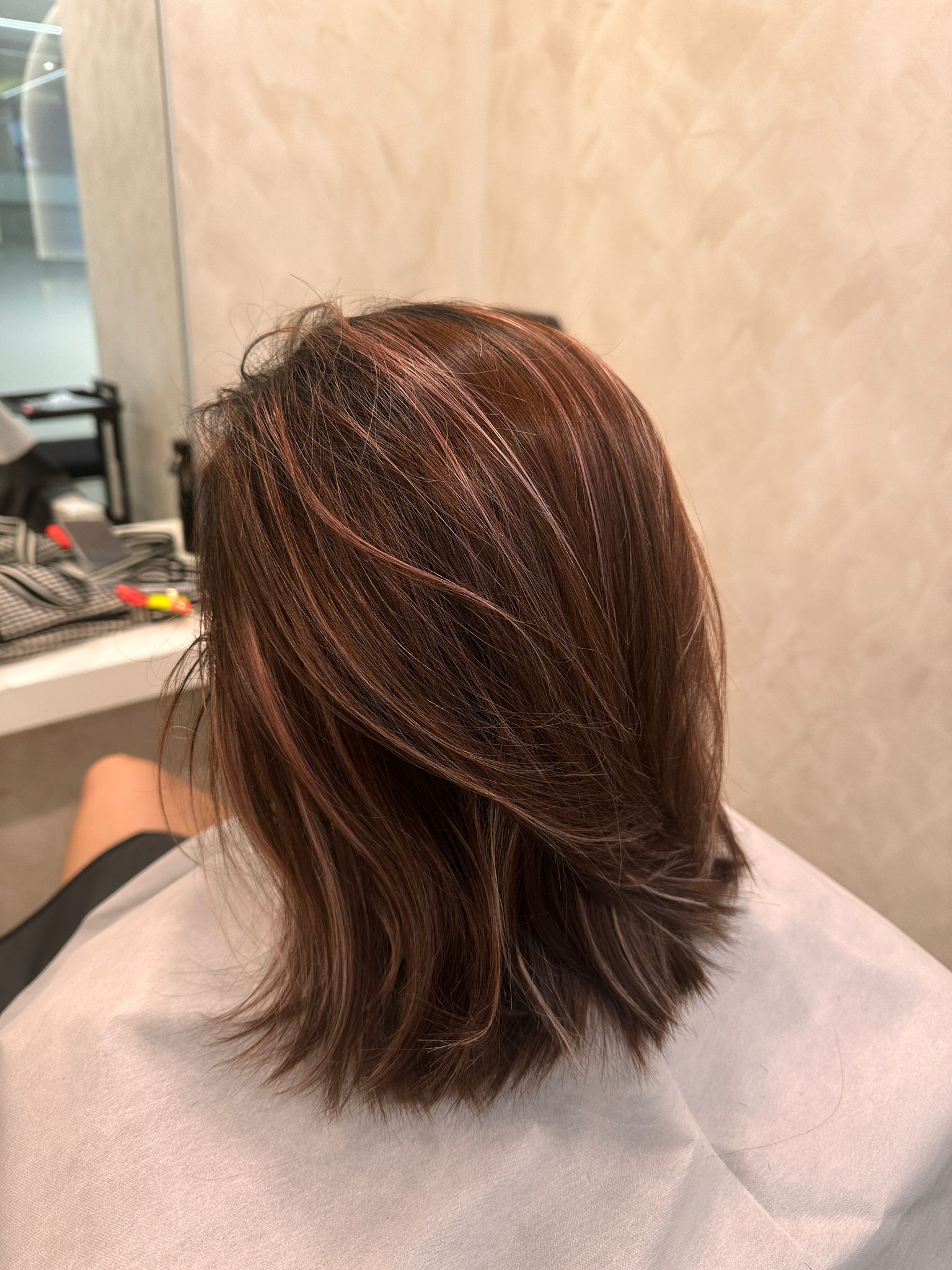Shoulder-length brown hair with a layered outline