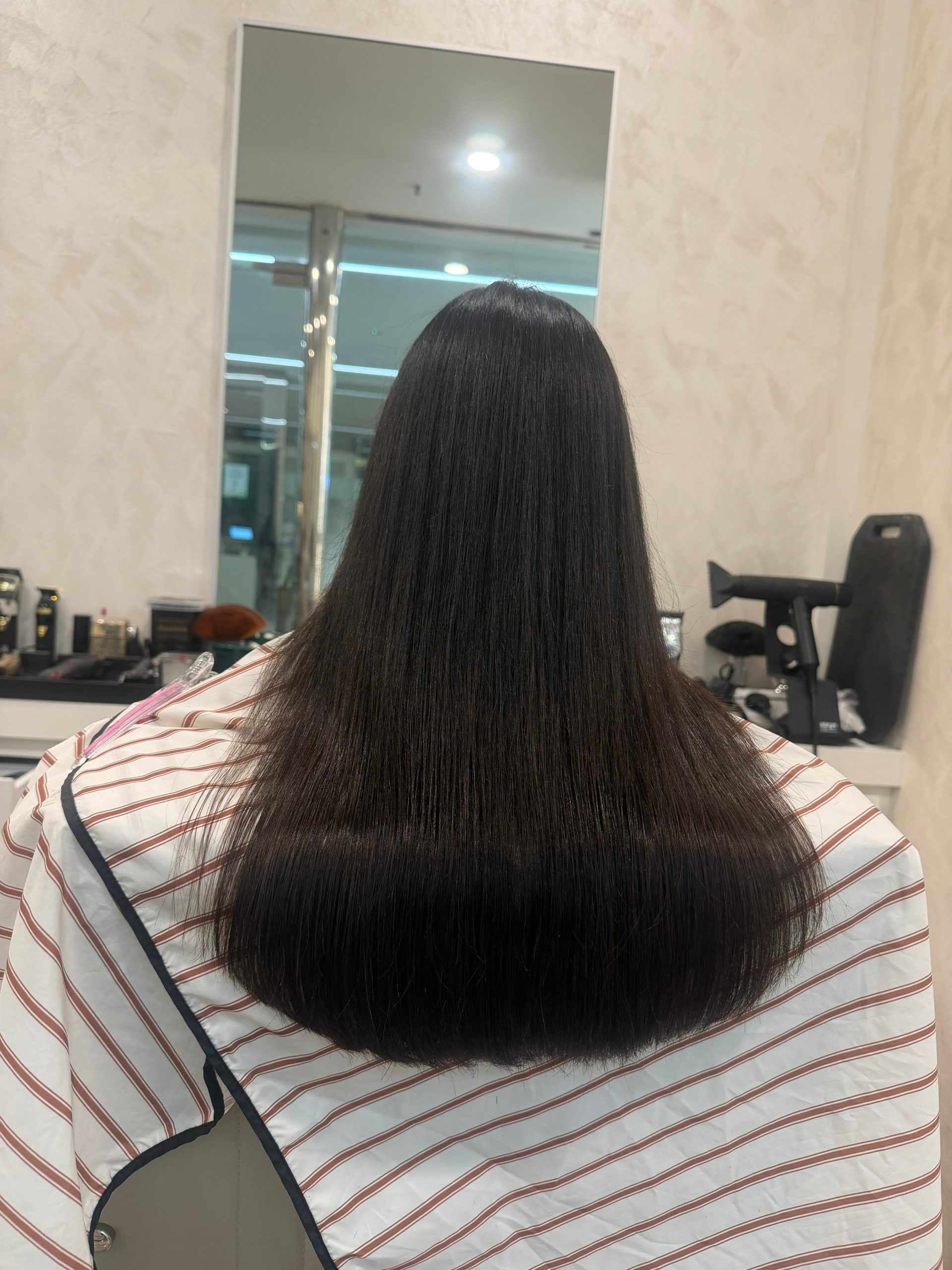 Back view of long dark hair with a rounded outline