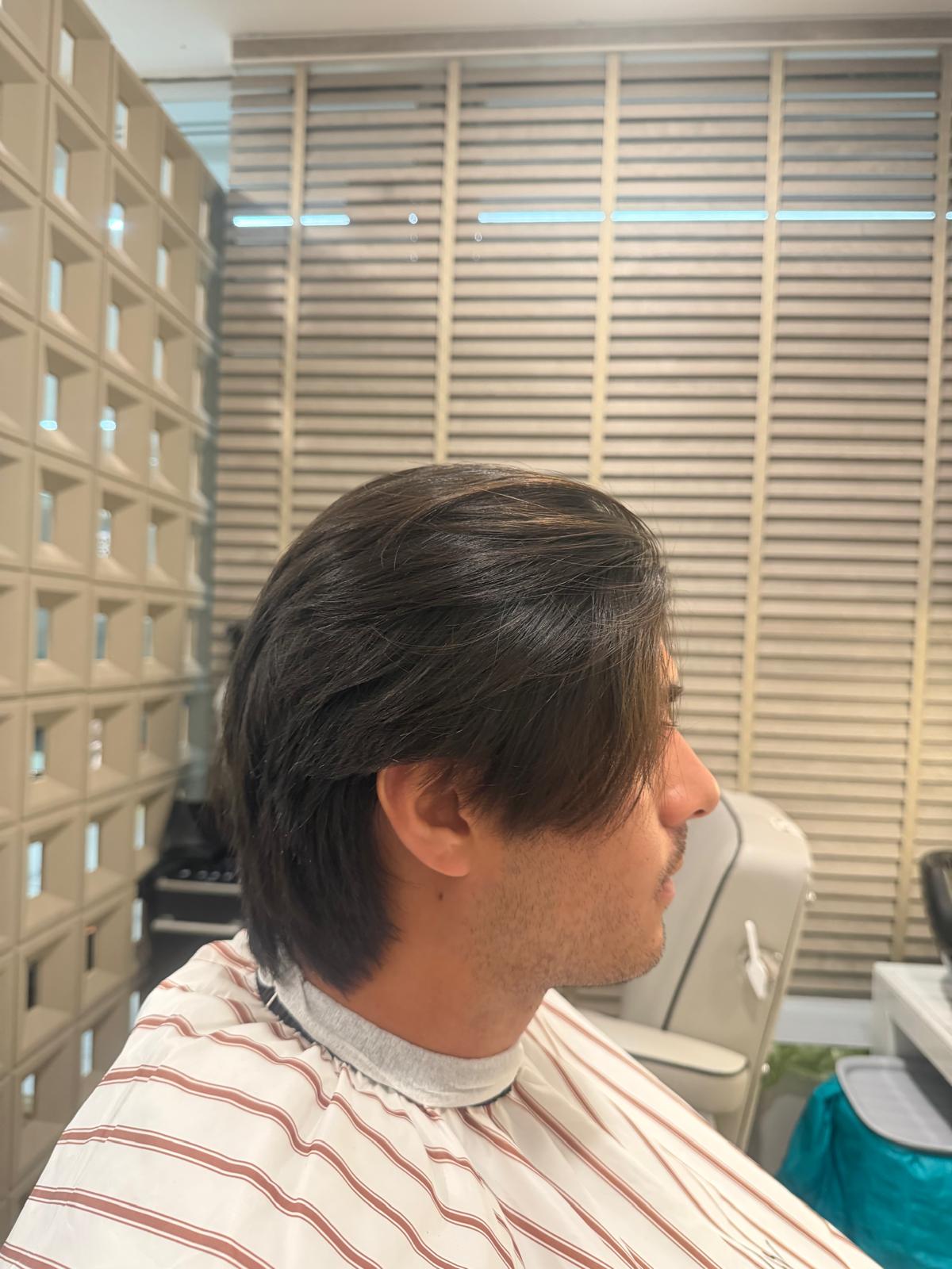 Longer straight hair swept back behind the ear
