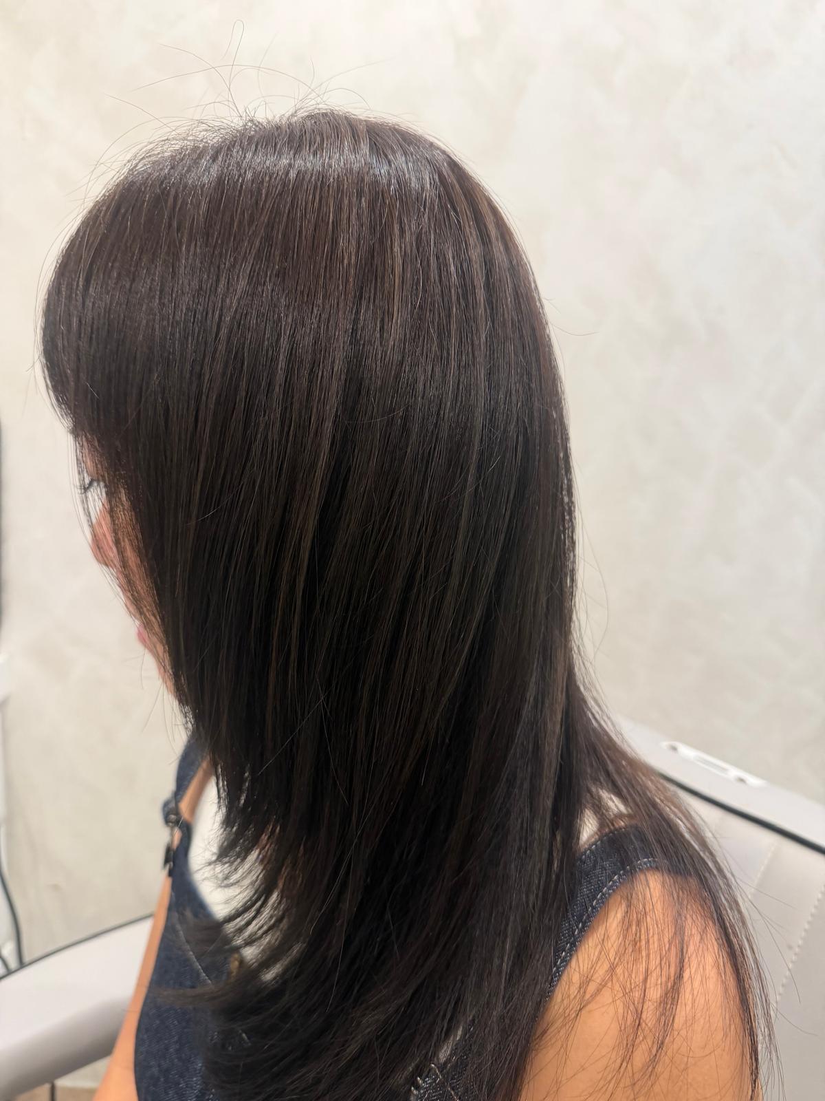 Dark shoulder-length hair with face-framing layers