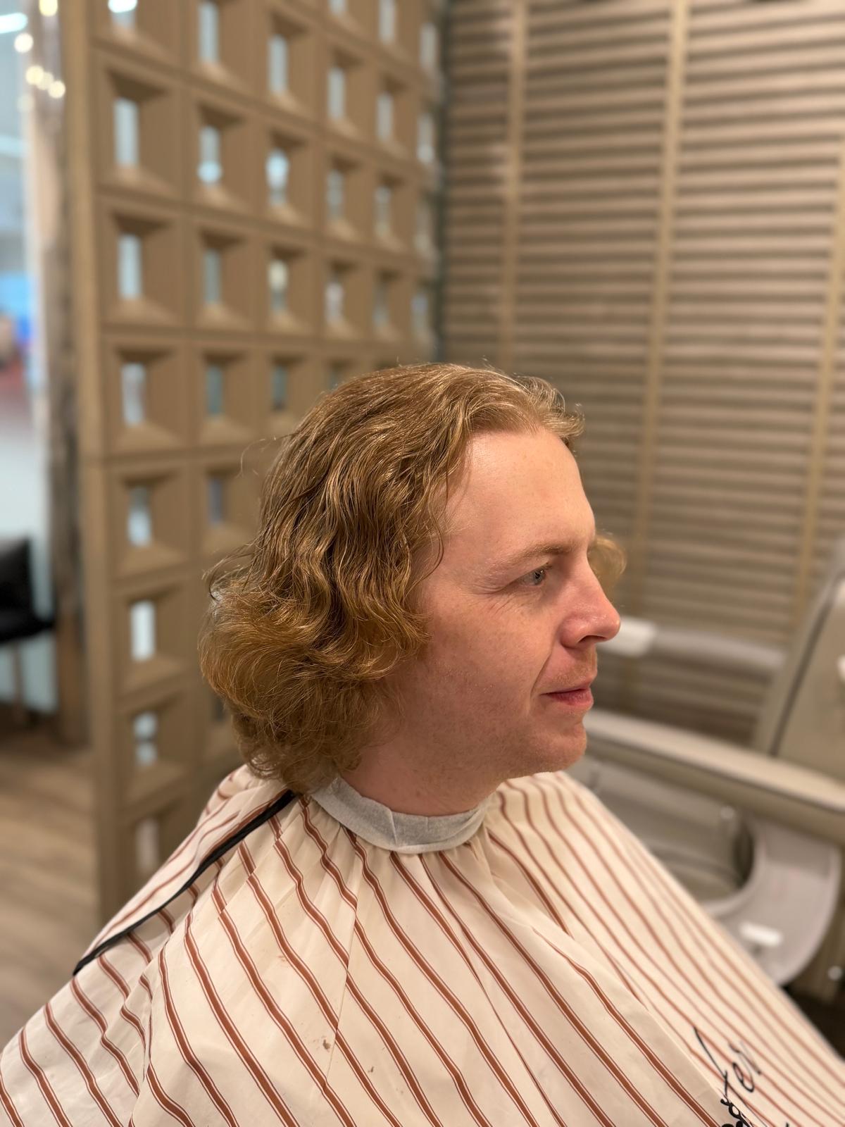 Side view of medium-length wavy hair in the salon
