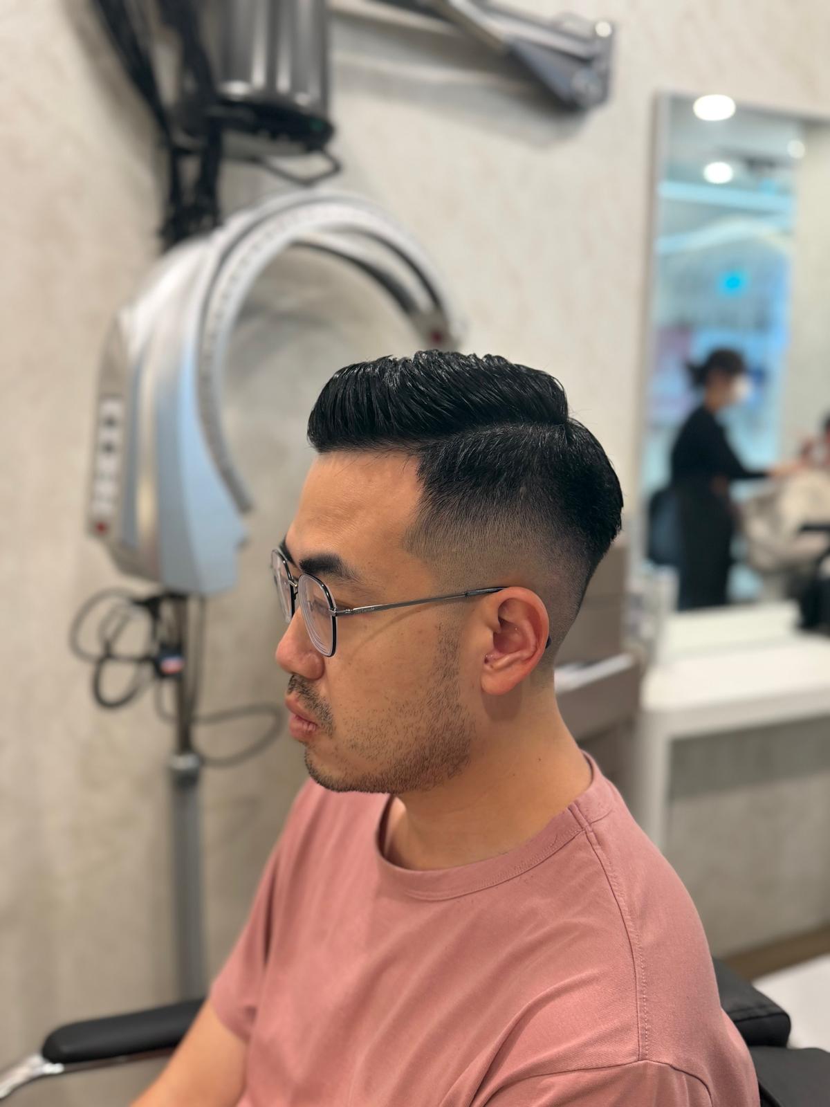 Side profile showing glasses, sideburns and a short haircut