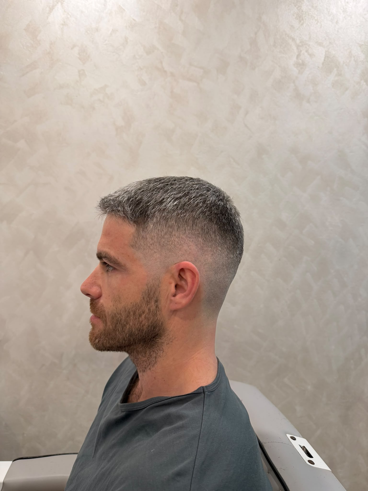 Short grey haircut showing the side and back outline