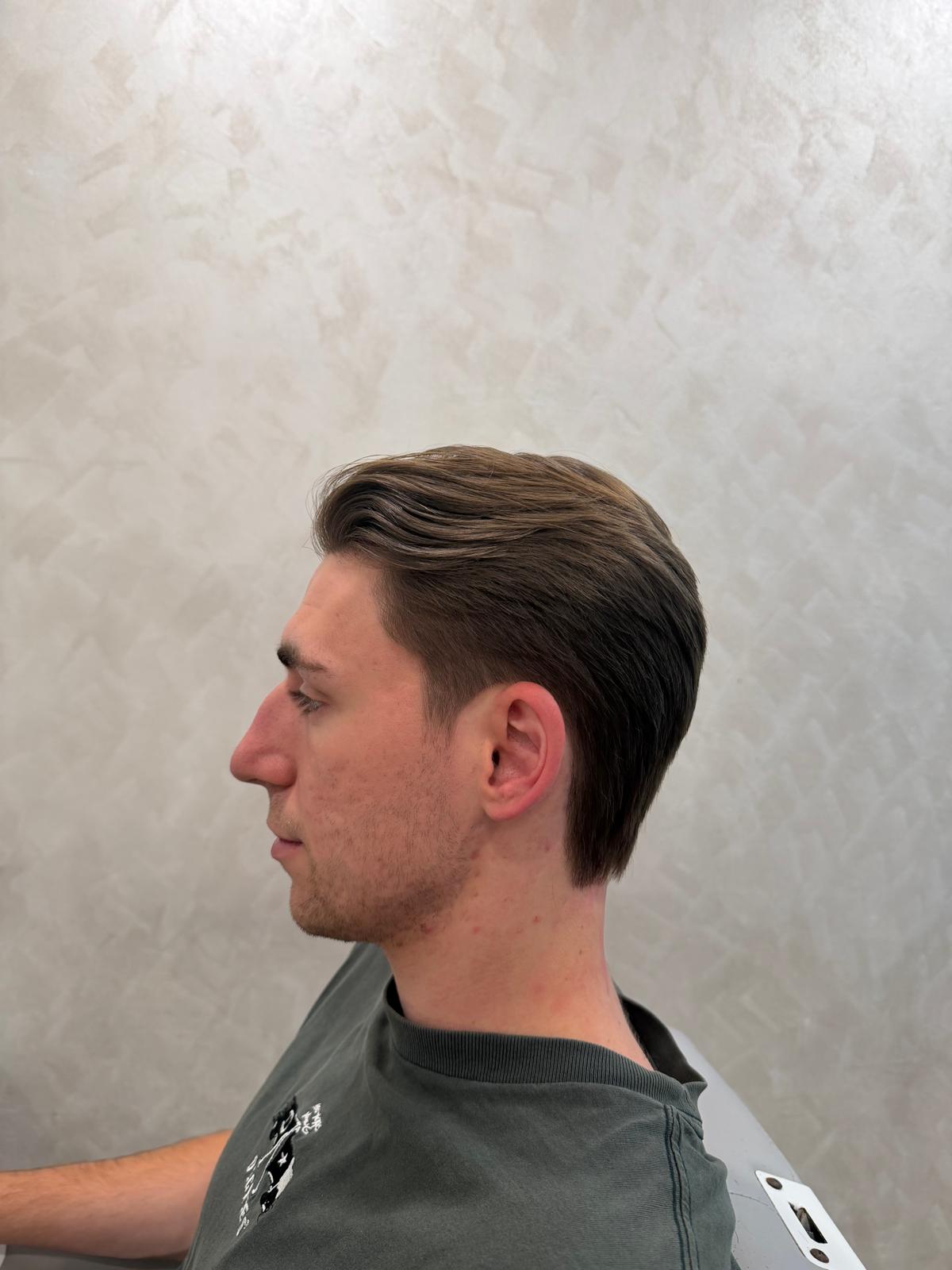 Side view of a swept-back haircut with a soft outline